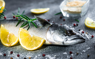 .raw fish with lemons on a blue background