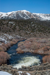 USA, California, Mono County, Bridgeport Reservoir: THe outlet of the dam restaring the flow of the Walker River near the gauging station.
