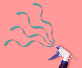 Atomizer sprays serpentine ribbon on a bright background . Minimal concept.