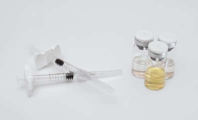 Medical syringes with drugs in glass bottles. Cosmetology concept.