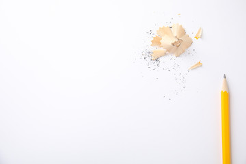 Pencil and shavings on white background, top view