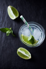 Gin and Tonic on black stone background. Close up.