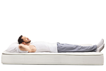 Man in nightwear sleeping on a mattress