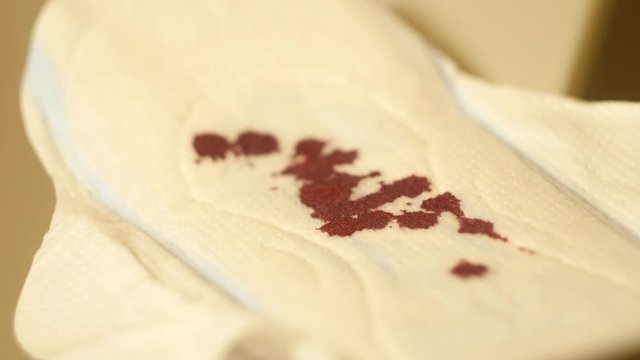 Blood drops fall on menstrual pads gaskets. Woman Hygiene products
