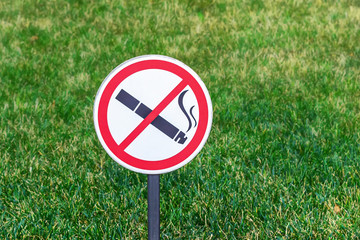 No Smoking sign on green lawn