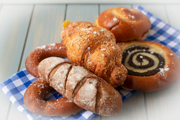 Varius types of fresh baked bread on blue squares napkin