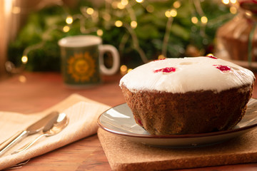 Traditional Christmas fruit cake, pudding with dried fruits, nuts and white glaze.