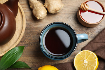 Tea with honey, ginger and lemon on wooden table, flat lay