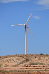 Lone wind turbine against a blue sky near the outback town of Coober Pedy in South Australian desert