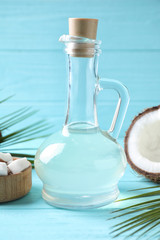Coconut oil on light blue wooden table, closeup