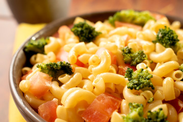 Creamy veggie macarroni salad. Pasta with tomatoes and broccoli. Delicious vegan dish