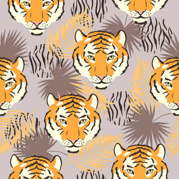 Vector seamless tropical pattern with tiger heads and palm leaves.