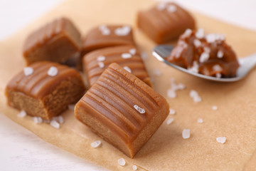Delicious salted caramel on parchment paper, closeup