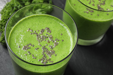Tasty kale smoothie with chia seeds on table, closeup