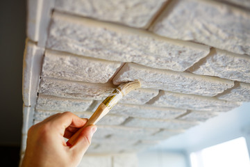 painting plaster decorative brick with white paint