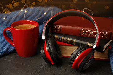 Books, coffee and headphones on grey table
