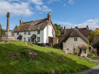 Fototapeta na wymiar Whitewashed homes surrounding the village green in the pretty Devon village of Lustleigh