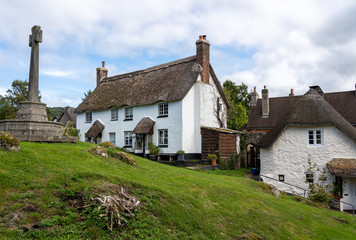 Fototapeta na wymiar Whitewashed homes surrounding the village green in the pretty Devon village of Lustleigh