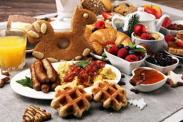 Breakfast served with coffee, orange juice, croissants, cereals and fruits. Balanced diet. Continental breakfast on christmas