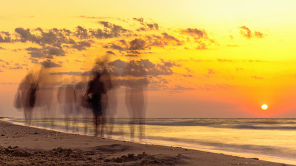 People and the dawn of sun on sea, silhouettes of people