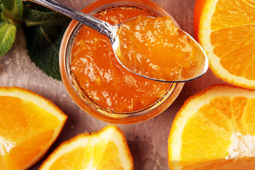 orange homemade jam marmelade in a glass jar. orange marmelade - 312596128
