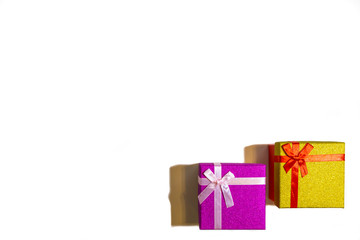 Fototapeta premium 2019.12.29, Moscow, Russia. Two bright gift boxes with red ribbon on a white background. Concept of Happy birthday or another festival.