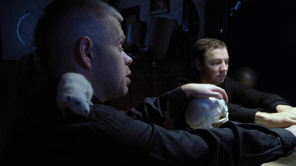 A session of spiritualism. a mage with a white rat on his shoulder casts a spell