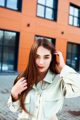 young pretty teenage girl posing cheerful happy smiling wearing street style outside in europe city, lifestyle people concept