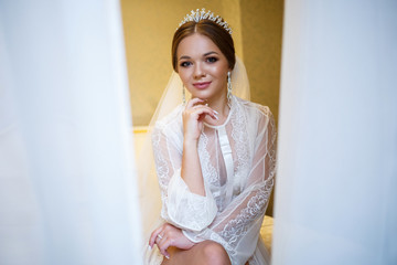 morning of a beautiful bride in a delicate white coat