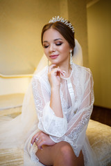 morning of a beautiful bride in a delicate white coat