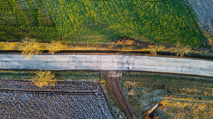 Aerial view of a small intersection in the fields. Winter village landscape background.
