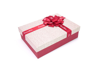 box with red ribbon and bow isolated on white