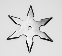 Silver shuriken with star shape isolated on white background.