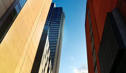 Perspective of high buildings in different colors and shapes.