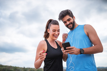Cute running couple using phone