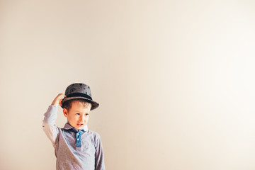Nice boy playing with a hat, blank background.