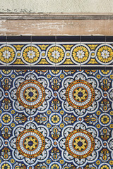 Painted tiles in old and ruined abandoned house.