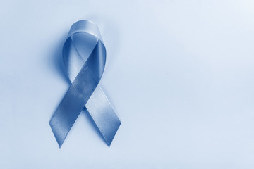 ribbon painted in trendy color of year 2020 Blue Classic on blue background, prostate cancer awareness concept. Copy space for text