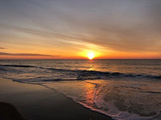 Sunrise with an orange sky over the Atlantic Ocean in Amagansett, Long Island, NY.