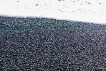 Pebble stones closeup on the shore in the blurry background