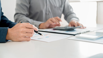 Administrator business man financial inspector and secretary making report calculating balance. Internal Revenue Service checking document. Audit concept