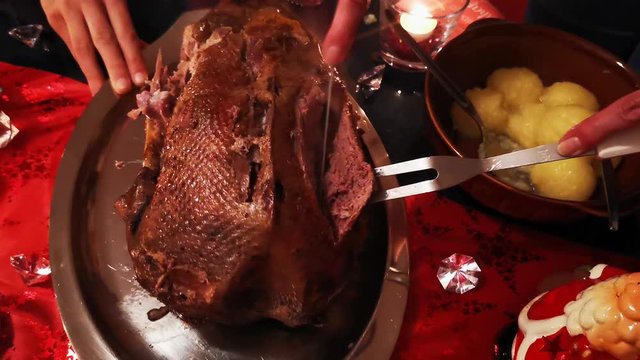 carving the christmas goose with knife