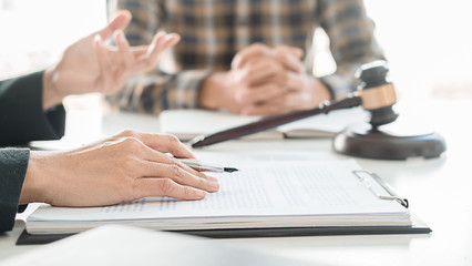 Judge gavel with Justice lawyers having team meeting at law firm background. Concepts of Law and Legal services.