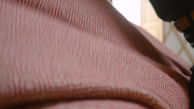 A blanket is placed over a client before a reiki crystal healing session