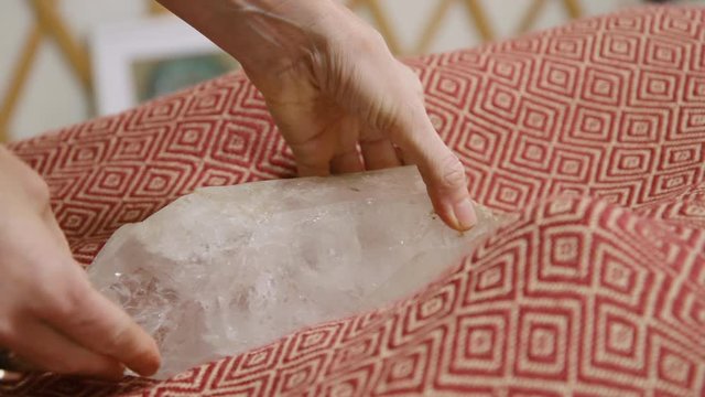 A large clear crystal is placed between the clients feet