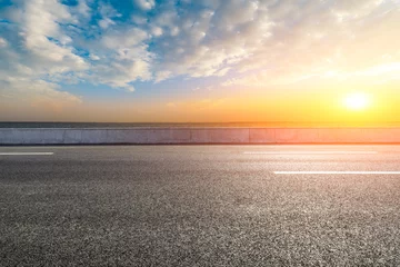Foto op Aluminium Empty asphalt road and lake with dreamy clouds at sunset. © ABCDstock