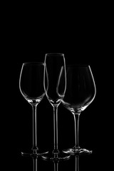 Glassware selection with wine, champagne and liquour glasses on the dark background.. Fine cristal glassware concept. Vertical