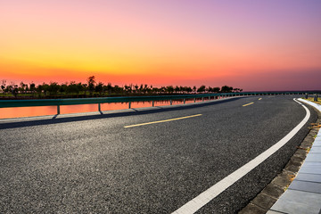 Empty asphalt road and beautiful sky at sunset.