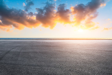 Race track road and lake with colorful clouds at sunset. © ABCDstock