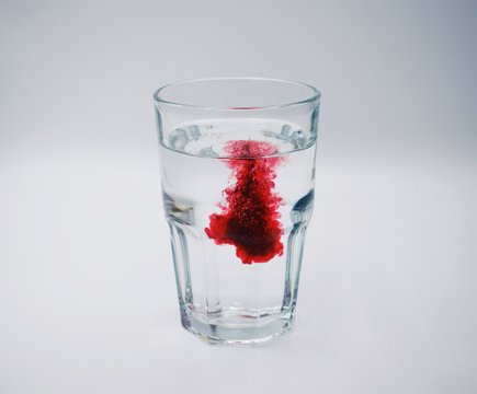 Burst Of Red Liquid In Glass Of Water, Red Color Water Enhancer